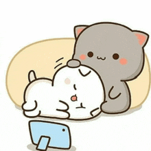 a cartoon of two cats laying on a pillow next to a tablet .