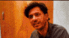 a blurry picture of a man sitting in front of a door