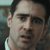 a man with a beard looks at the camera with a serious look on his face