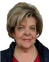 a woman wearing a pearl necklace and a red shirt smiles for the camera