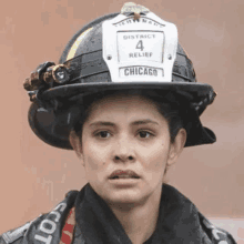 a woman wearing a helmet that says district 4 relief