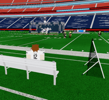 a person wearing a white jersey with the number 12 sits on a bench