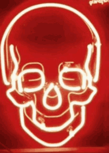 a neon sign of a skull wearing headphones