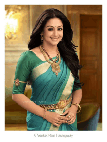 a woman wearing a blue saree and gold jewelry is photographed by g venkat ram