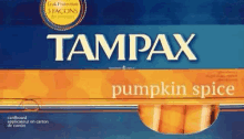 a box of tampax pumpkin spice tampons is sitting on a table .