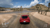 a red sports car is driving down a dirt road with the number 72 on the bottom right