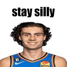 a basketball player wearing a blue jersey with the words `` stay silly '' written on it .