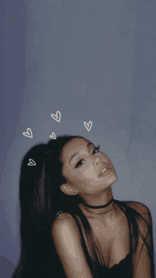 ariana grande is wearing a choker and a black top