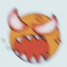 a blurred image of a devil emoji with horns and teeth .