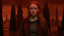 a woman in a red jacket stands in front of a red background