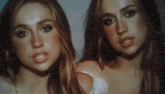 two women are standing next to each other and looking at the camera with their mouths open