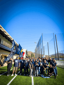 a group of people standing on a field with a flag that says ' eagles '