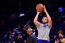 basketball player wearing a shirt that says warriors