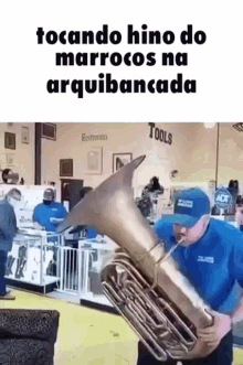 a man is playing a tuba in a store with a caption that says tocando hino do marocos na arquibancada .