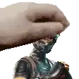 a hand is putting a hat on a statue of a robot .