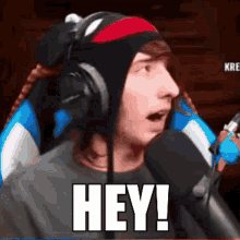 a man wearing headphones and a headband is saying hey