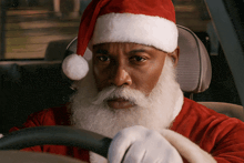 a man in a santa suit is driving a car