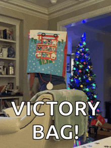 a man is sitting on a couch with a victory bag on his head