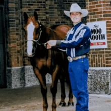 a man in a cowboy hat stands next to a horse in front of a sign that says " the moo mooth "