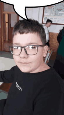 a young boy wearing glasses and a black shirt that says " freedom love world "