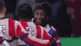 a group of hockey players are hugging each other and one has the number 42 on his back .