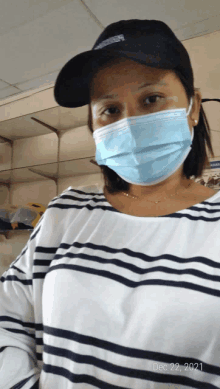 a woman wearing a face mask and a hat with the date dec 22 2021 on the bottom