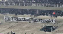 a banner in a stadium says president debile adopte