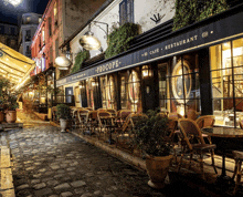 a cobblestone street with tables and chairs outside of a restaurant called procopé