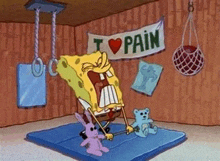 spongebob squarepants is sitting on a mat in a gym with a teddy bear and a rabbit .