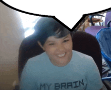 a boy wearing a shirt that says " my brain "