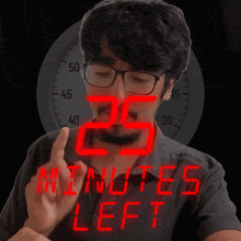 a man wearing glasses is pointing at the number 25 in red