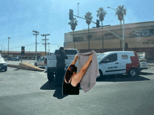 a woman is holding a towel in front of a mr truck