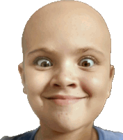 a young girl with a bald head is smiling and making a funny face