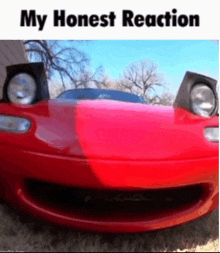 a red sports car with its headlights up and the words my honest reaction below it