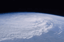 a view of a hurricane from space with a dark sky in the background