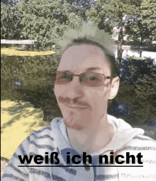 a man wearing glasses and a striped shirt has the words weiß ich nicht written below him