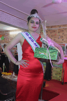 a woman in a red dress with a sash that says ' m-bb-mt ' on it