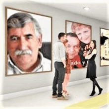 a man and a woman are standing in front of a wall with portraits of a man and a woman on it .