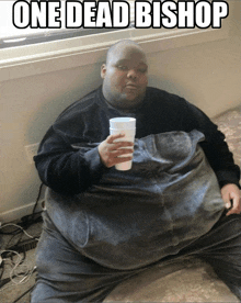 a very fat man is sitting on a bed holding a cup with the caption one dead bishop above him