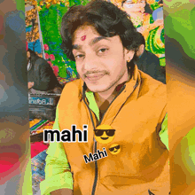 a man wearing a yellow jacket with the name mahi on it