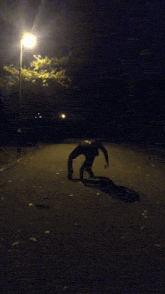 a person walking down a street at night
