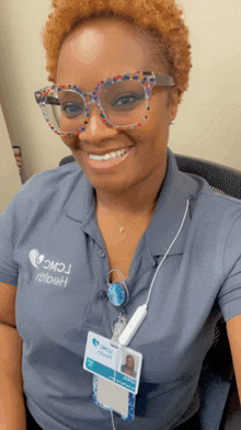 a woman wearing glasses and a name tag that says ' jacqueline ' on it