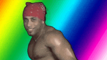 a shirtless man wearing a red bandana is standing in front of a rainbow background .