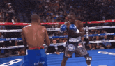 two boxers in a boxing ring one of whom is wearing crawford 's shorts