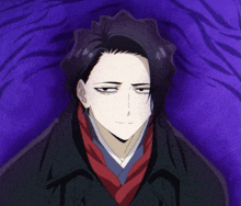 a man with black hair and a red scarf