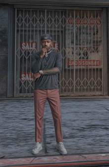 a man stands in front of a store with a sale sign