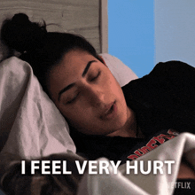 a woman laying in bed with the words " i feel very hurt " on the bottom