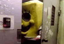 a yellow spongebob costume is standing in a doorway .