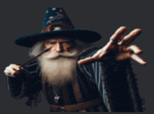 a man in a wizard costume is holding a wand in his hand