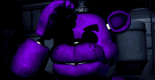 a purple teddy bear in a dark room